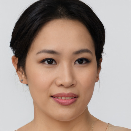 Joyful asian young-adult female with short  brown hair and brown eyes