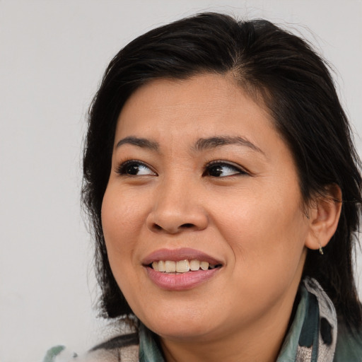 Joyful asian young-adult female with long  brown hair and brown eyes