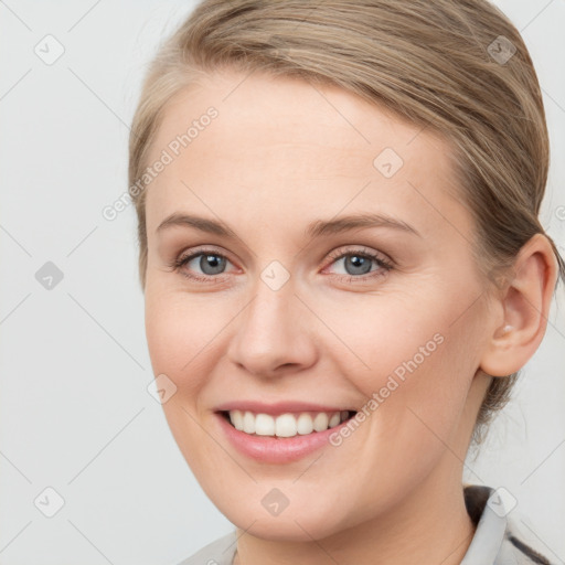 Joyful white young-adult female with medium  brown hair and blue eyes