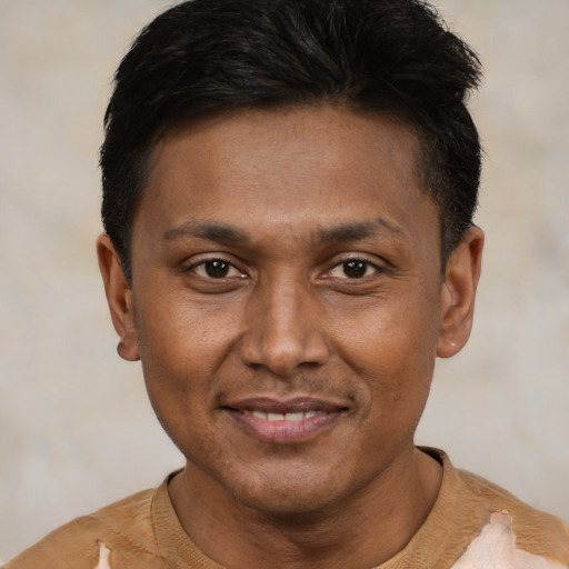 Joyful black adult male with short  black hair and brown eyes