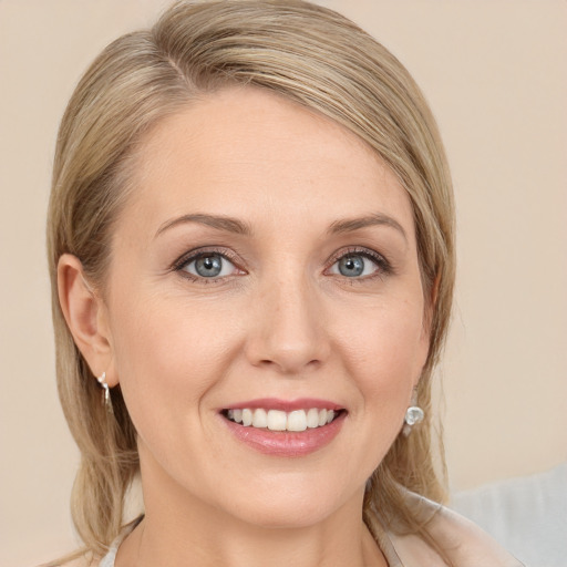 Joyful white young-adult female with long  brown hair and blue eyes