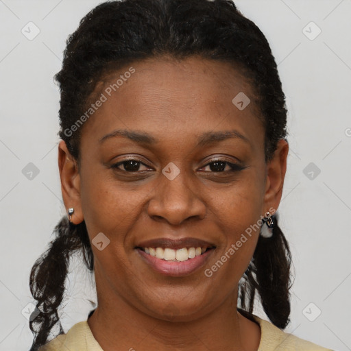 Joyful black adult female with short  brown hair and brown eyes