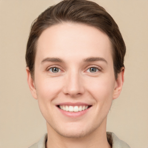 Joyful white young-adult female with short  brown hair and grey eyes