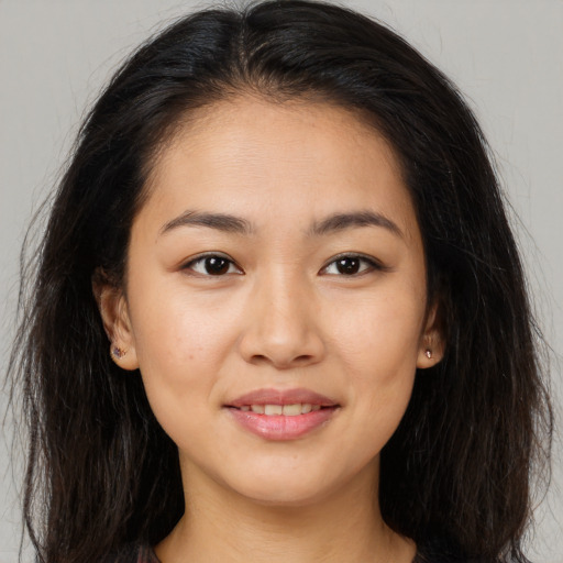 Joyful asian young-adult female with long  brown hair and brown eyes