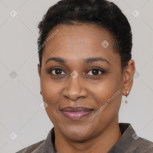 Joyful black adult female with short  black hair and brown eyes