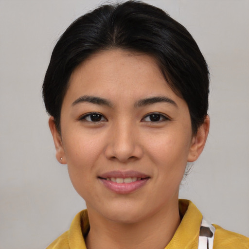Joyful asian young-adult female with short  brown hair and brown eyes