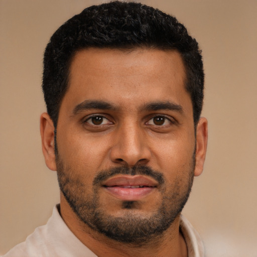 Joyful black young-adult male with short  black hair and brown eyes