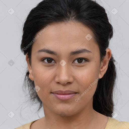 Joyful latino young-adult female with medium  brown hair and brown eyes