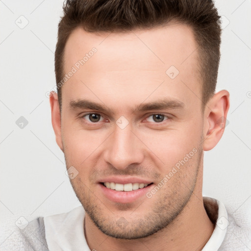 Joyful white young-adult male with short  brown hair and brown eyes