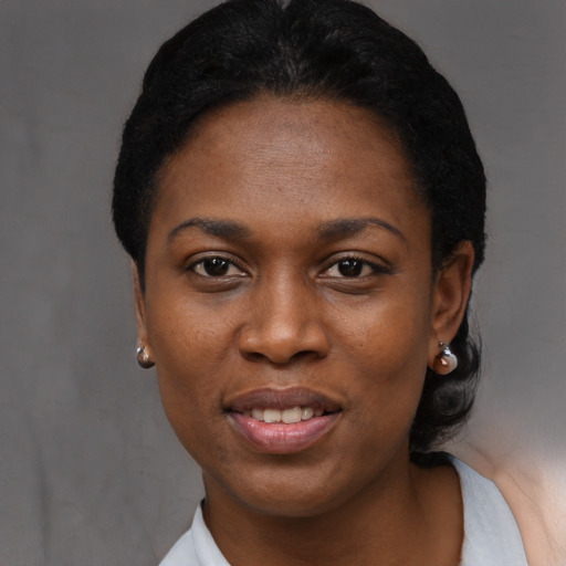 Joyful black young-adult female with short  black hair and brown eyes