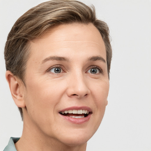 Joyful white adult female with short  brown hair and grey eyes