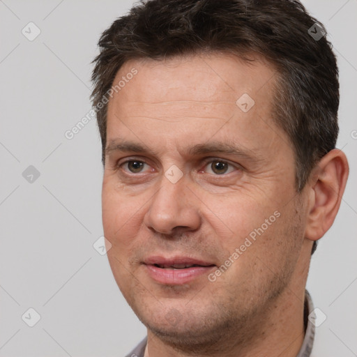 Joyful white adult male with short  brown hair and brown eyes