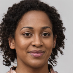 Joyful black young-adult female with medium  brown hair and brown eyes