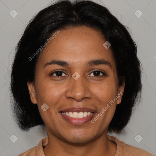 Joyful latino adult female with medium  brown hair and brown eyes