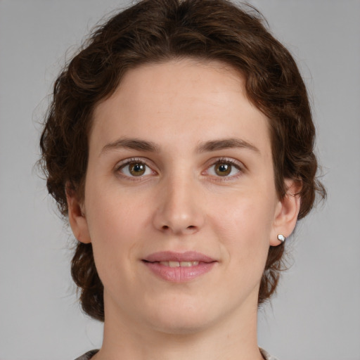 Joyful white young-adult female with medium  brown hair and green eyes