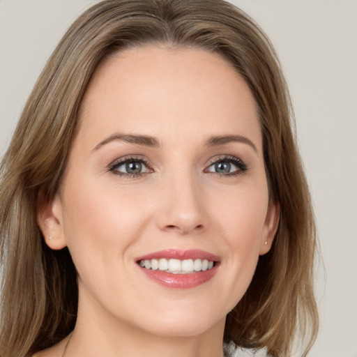 Joyful white young-adult female with medium  brown hair and green eyes