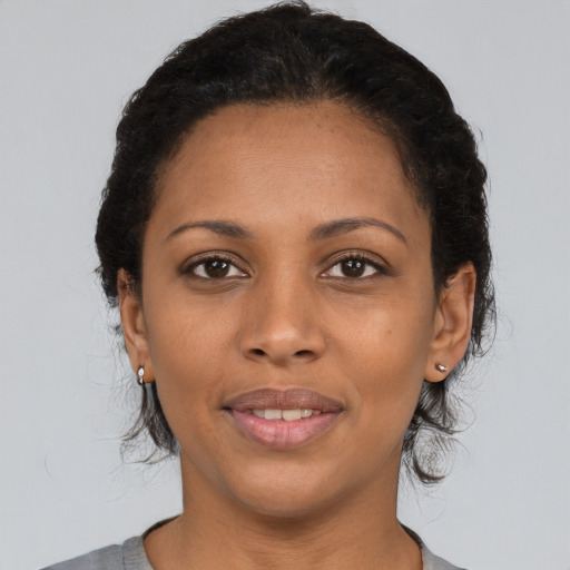 Joyful latino young-adult female with medium  black hair and brown eyes
