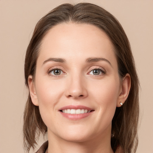 Joyful white young-adult female with long  brown hair and grey eyes