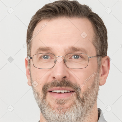 Joyful white adult male with short  brown hair and grey eyes