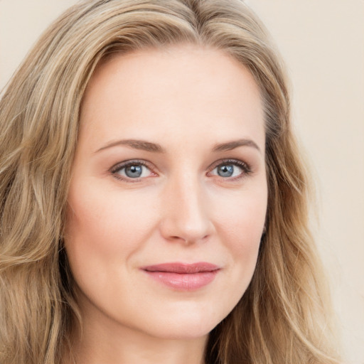 Joyful white young-adult female with long  brown hair and blue eyes