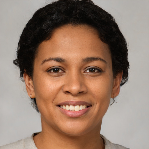 Joyful latino young-adult female with short  brown hair and brown eyes