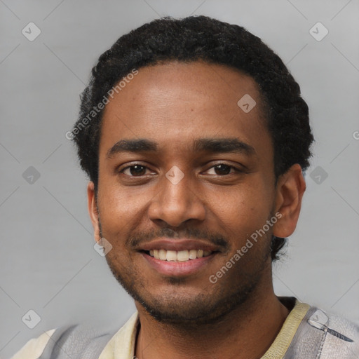 Joyful black young-adult male with short  black hair and brown eyes