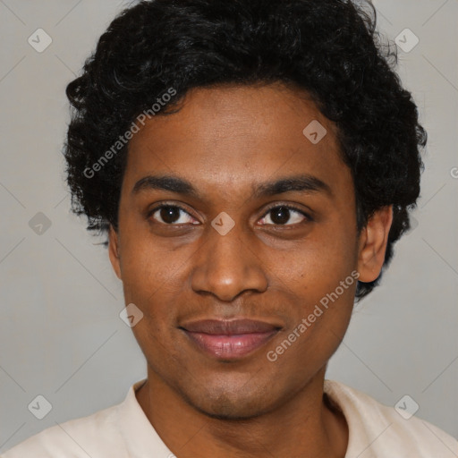 Joyful black young-adult male with short  brown hair and brown eyes