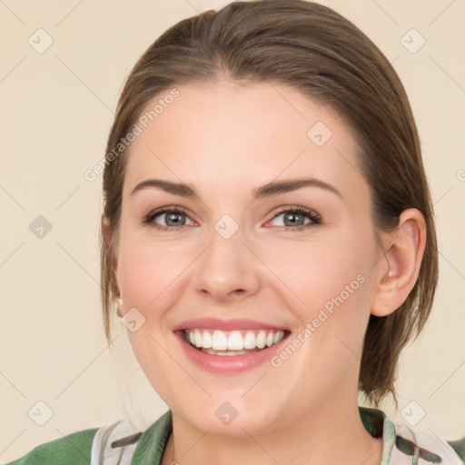 Joyful white young-adult female with medium  brown hair and green eyes