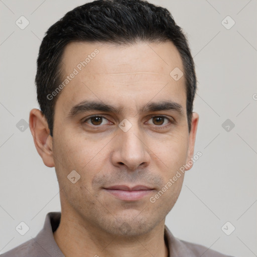 Joyful white young-adult male with short  black hair and brown eyes