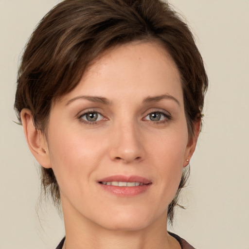 Joyful white young-adult female with medium  brown hair and grey eyes