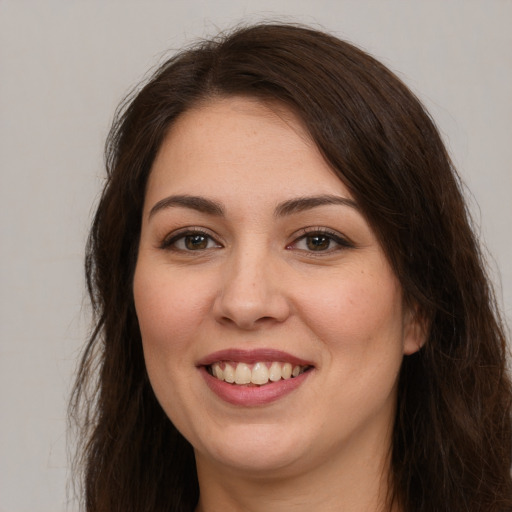 Joyful white young-adult female with long  brown hair and brown eyes