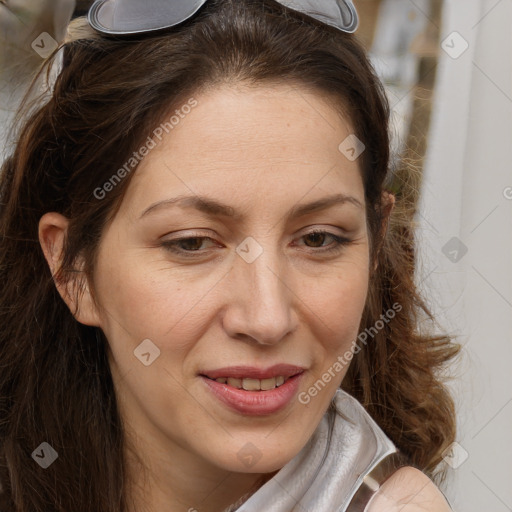 Joyful white adult female with long  brown hair and brown eyes