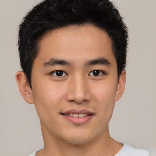 Joyful asian young-adult male with short  brown hair and brown eyes