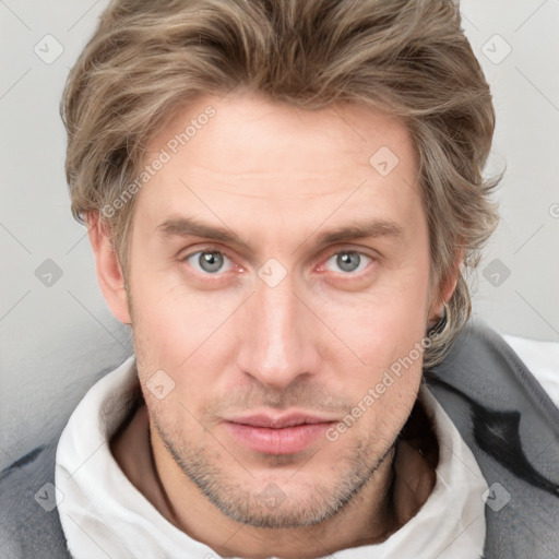 Joyful white adult male with short  brown hair and blue eyes