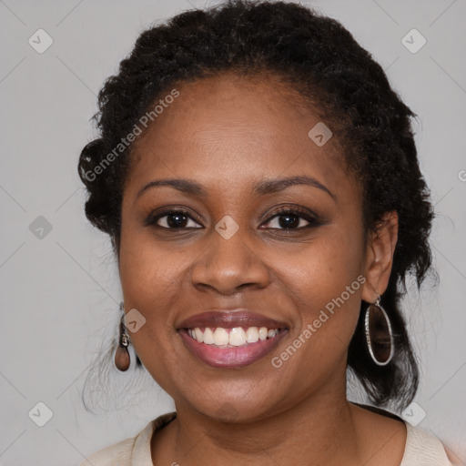 Joyful black young-adult female with long  brown hair and brown eyes