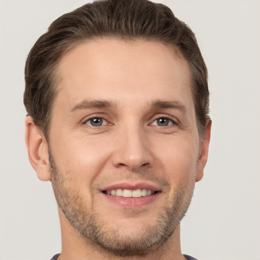 Joyful white adult male with short  brown hair and brown eyes