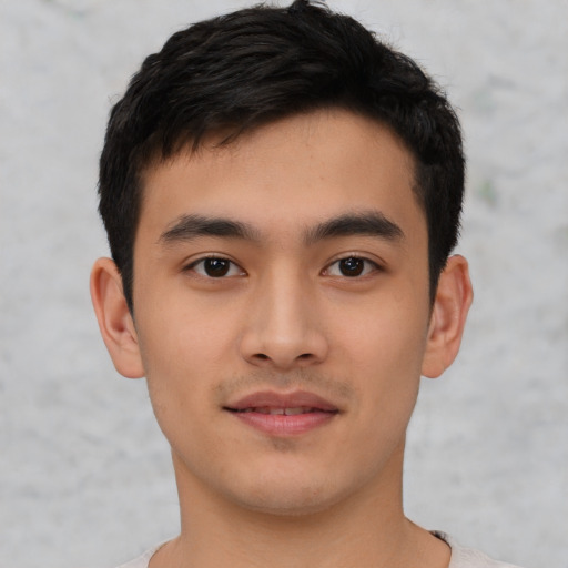 Joyful asian young-adult male with short  black hair and brown eyes