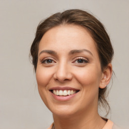 Joyful white young-adult female with medium  brown hair and brown eyes