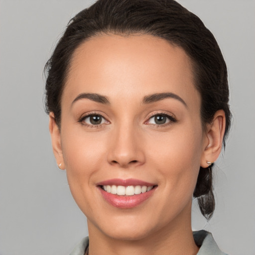 Joyful white young-adult female with medium  brown hair and brown eyes