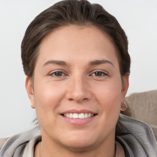 Joyful white young-adult female with short  brown hair and brown eyes