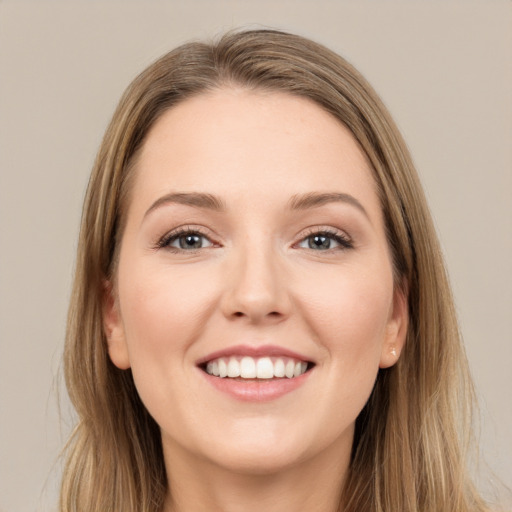 Joyful white young-adult female with long  brown hair and grey eyes