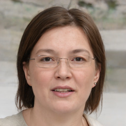 Joyful white adult female with medium  brown hair and grey eyes