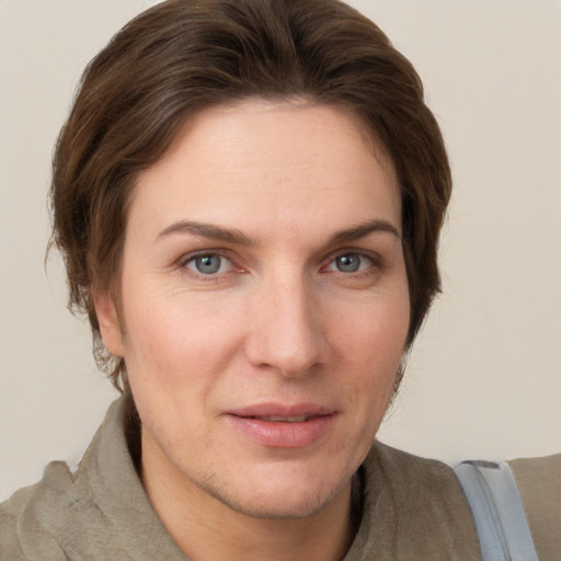 Joyful white young-adult female with short  brown hair and grey eyes