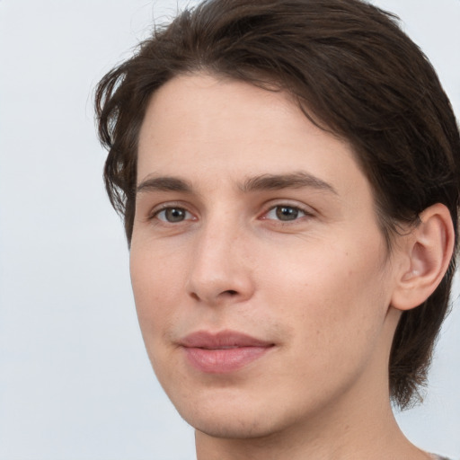 Joyful white young-adult male with medium  brown hair and brown eyes