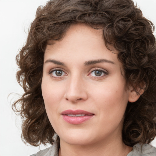 Joyful white young-adult female with medium  brown hair and green eyes