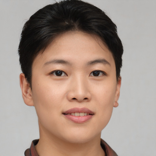 Joyful asian young-adult female with short  brown hair and brown eyes