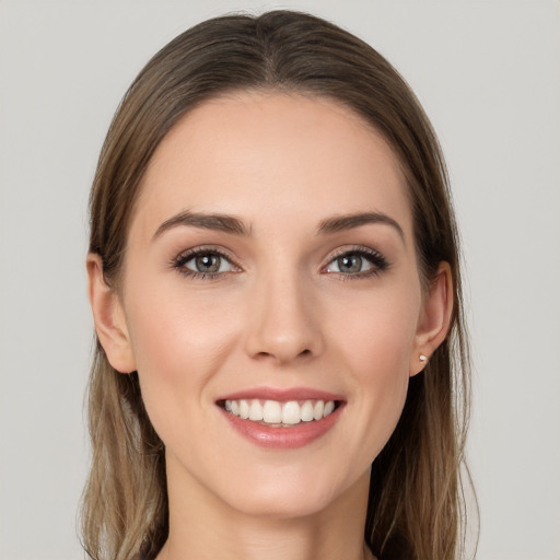 Joyful white young-adult female with long  brown hair and grey eyes