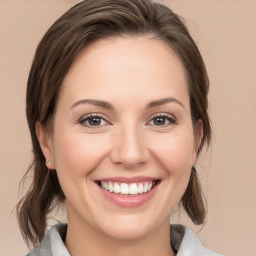 Joyful white young-adult female with medium  brown hair and brown eyes