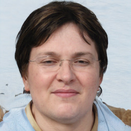 Joyful white adult female with medium  brown hair and blue eyes