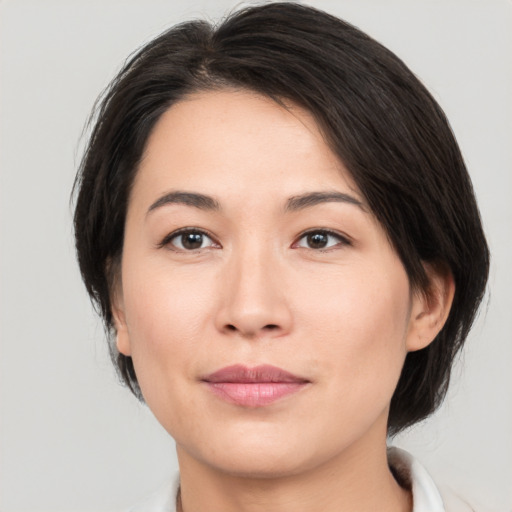 Joyful white young-adult female with medium  brown hair and brown eyes